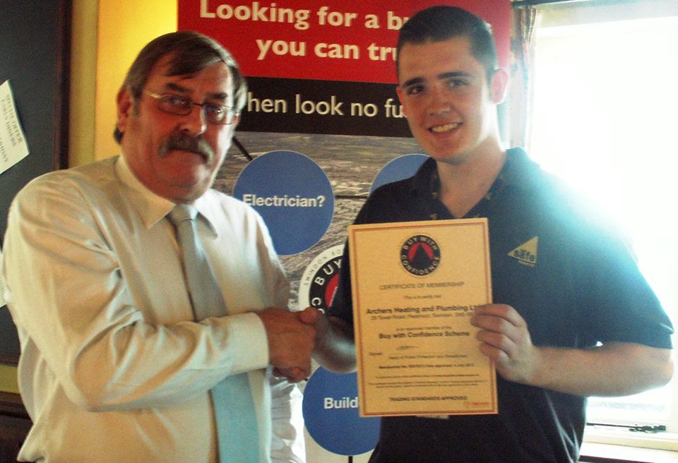 Matthew Archer holding the company's Buy With Confidence membership certificate